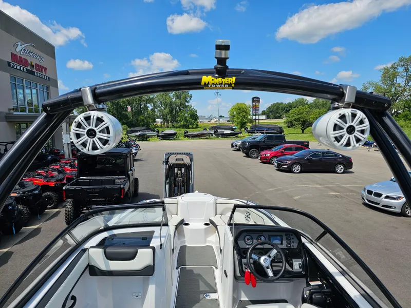 Slide: The Image of 2017 Yamaha SX210 boat with Monster Tower speakers, parked at a dealership under a clear blue sky. - 22