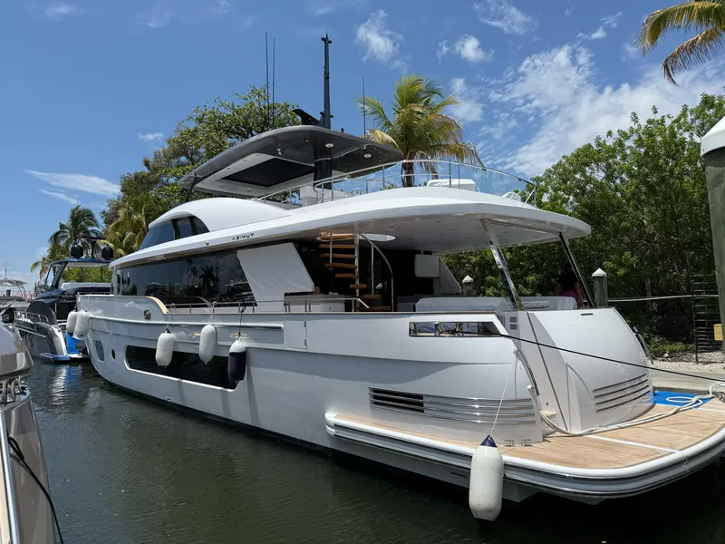 Slide: The Image of 2026 Azimut Magellano 25M yacht docked in a marina under cloudy skies. - 1