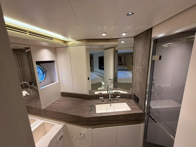 Slide: The Image of Luxurious interior of 2026 Azimut Magellano 25M yacht, featuring a bedroom and bathroom. - 11