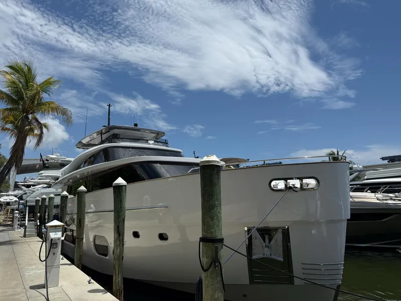 Slide: The Image of Azimut Magellano 25M 2026 yacht docked under a clear blue sky. - 2