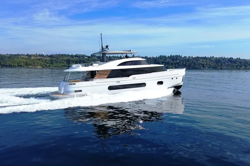 Slide: The Image of 2026 Azimut Magellano 25M yacht cruising on a serene lake under a clear blue sky. - 110