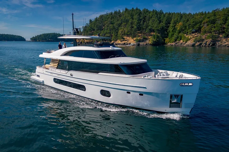 Slide: The Image of 2026 Azimut Magellano 25M yacht cruising on a scenic lake with forested shoreline. - 100