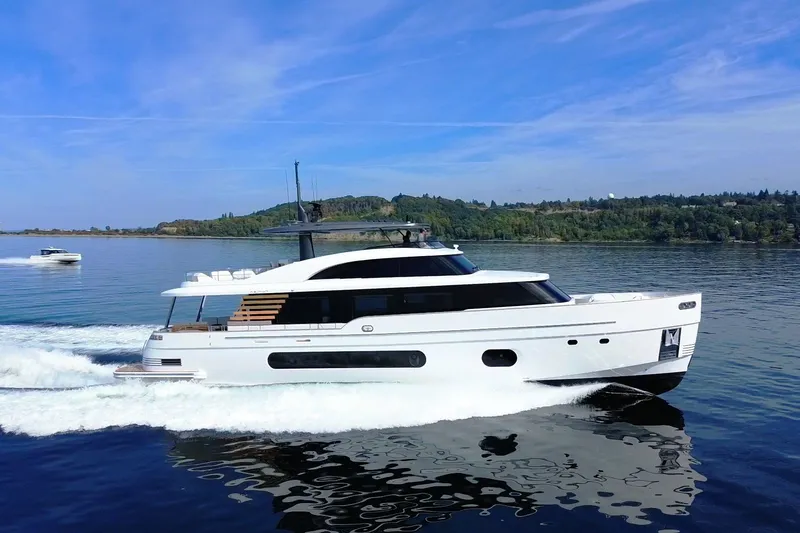 Slide: The Image of 2026 Azimut Magellano 25M yacht cruising on a serene lake under a clear blue sky. - 105