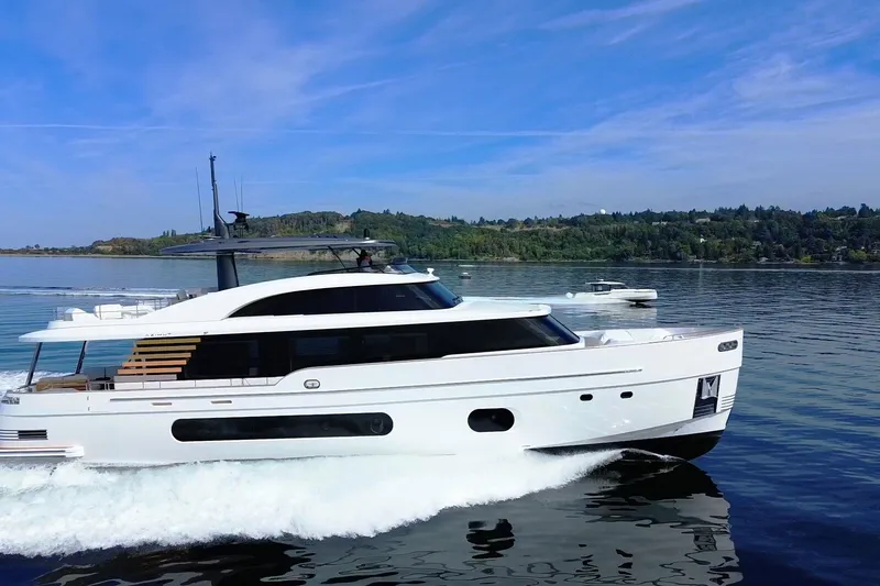 Slide: The Image of 2026 Azimut Magellano 25M yacht cruising on a serene lake under a clear blue sky. - 106