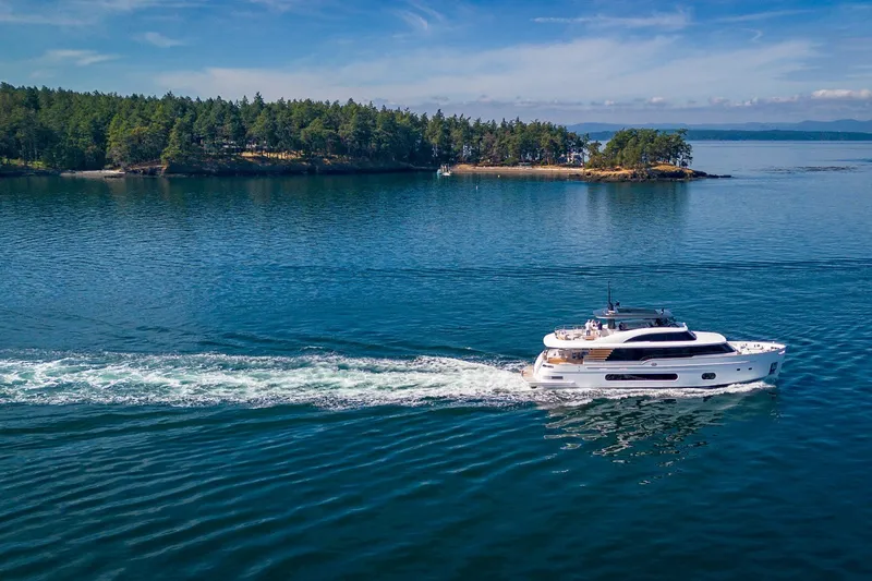 Slide: The Image of Azimut Magellano 25M yacht cruising near a scenic island, 2026 model. - 102