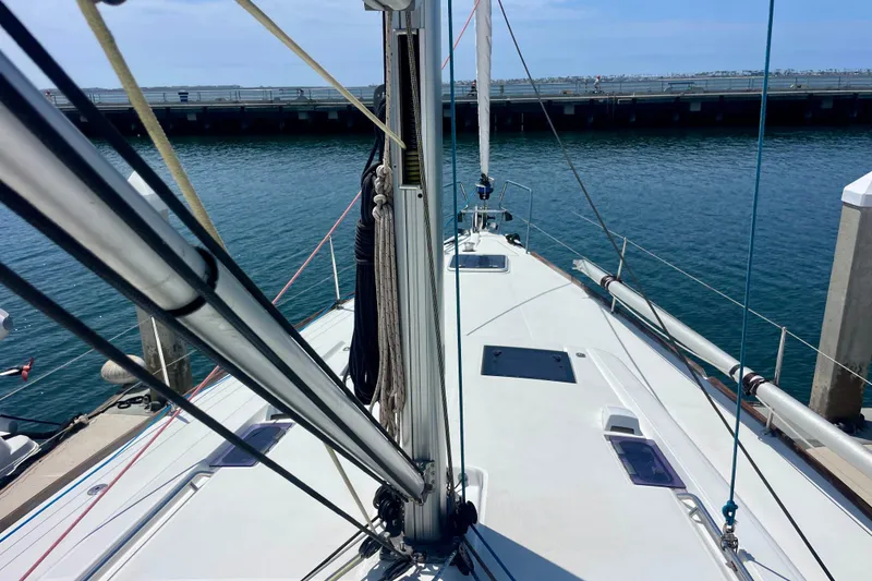 Slide: The Image of 2018 Beneteau Oceanis 48 sailboat docked, view from deck, clear blue water. - 11