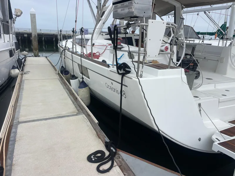 Slide: The Image of 2018 Beneteau Oceanis 48 yacht docked at marina, side view. - 2