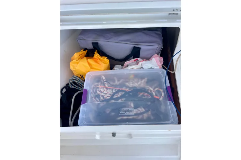 Slide: The Image of Storage compartment on a 2018 Beneteau Oceanis 48 with ropes and bags. - 23
