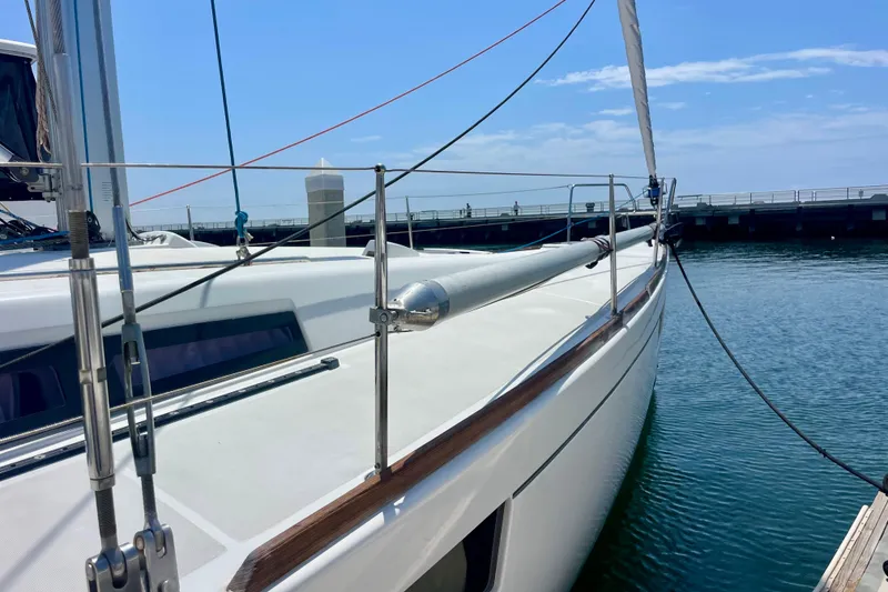 Slide: The Image of 2018 Beneteau Oceanis 48 sailboat docked at marina under clear blue sky. - 27