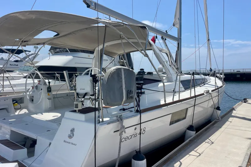 Slide: The Image of 2018 Beneteau Oceanis 48 yacht docked at marina under clear blue sky. - 3