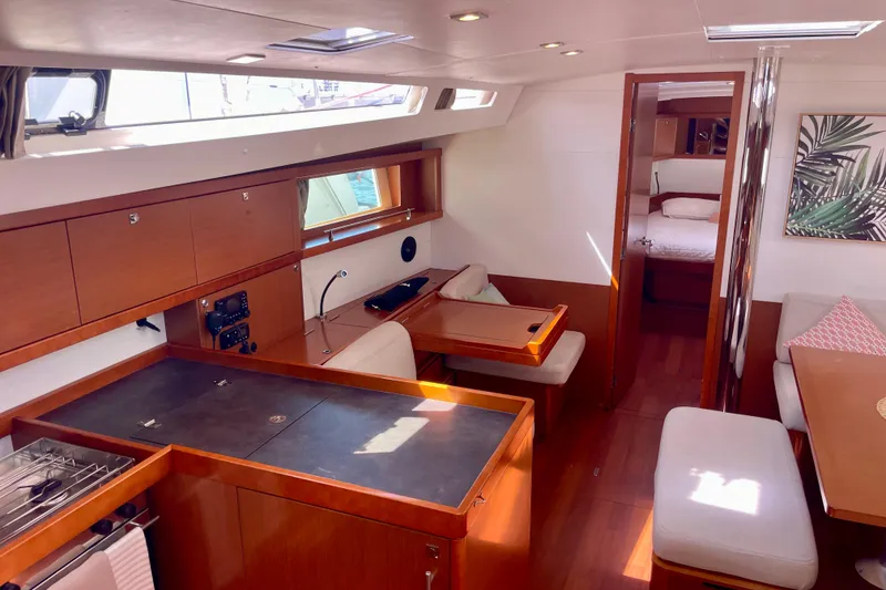 Slide: The Image of Interior of 2018 Beneteau Oceanis 48 yacht, featuring modern kitchen and cozy seating area. - 38