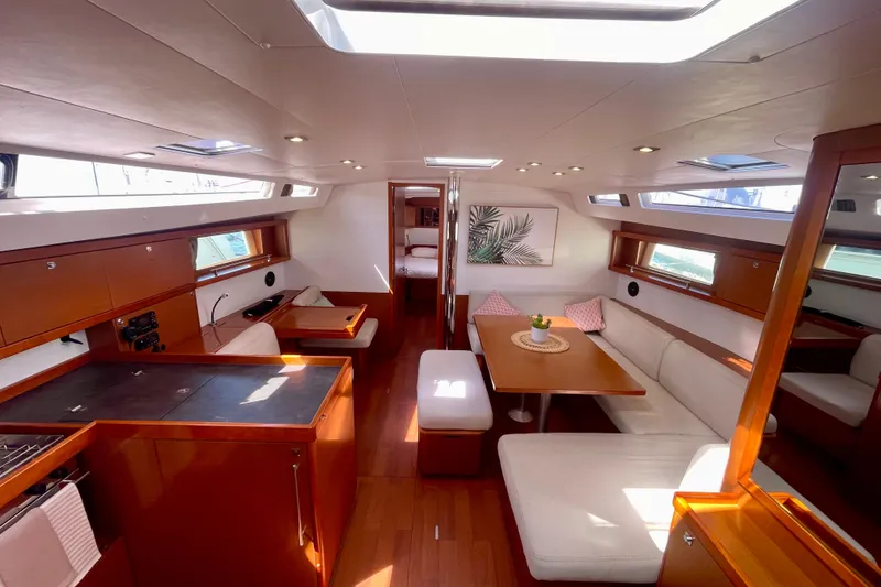 Slide: The Image of Luxurious interior of 2018 Beneteau Oceanis 48 yacht with modern furnishings and ample natural light. - 40