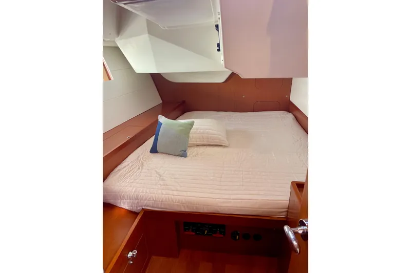 Slide: The Image of Cozy cabin interior of 2018 Beneteau Oceanis 48 yacht with neatly made bed. - 43