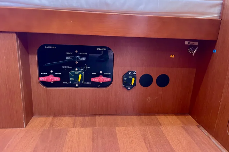 Slide: The Image of Control panel of a 2018 Beneteau Oceanis 48 yacht, featuring battery and breaker switches. - 46