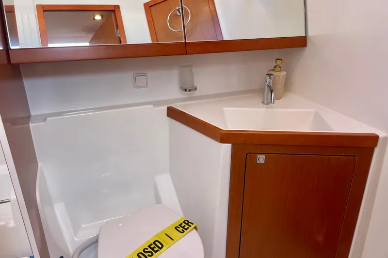 Slide: The Image of Bathroom interior of 2018 Beneteau Oceanis 48 yacht with sink and closed toilet. - 47