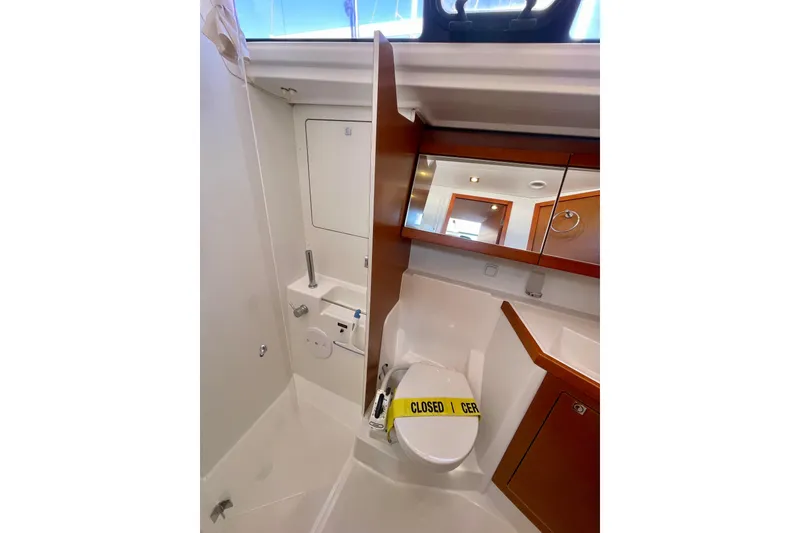 Slide: The Image of Bathroom interior of 2018 Beneteau Oceanis 48 yacht with closed toilet. - 49