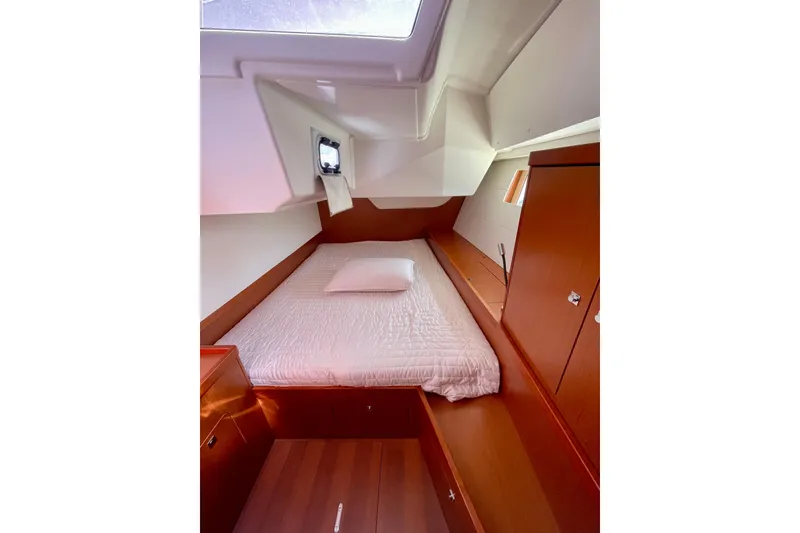 Slide: The Image of 2018 Beneteau Oceanis 48 cabin interior with bed and wooden cabinetry. - 51