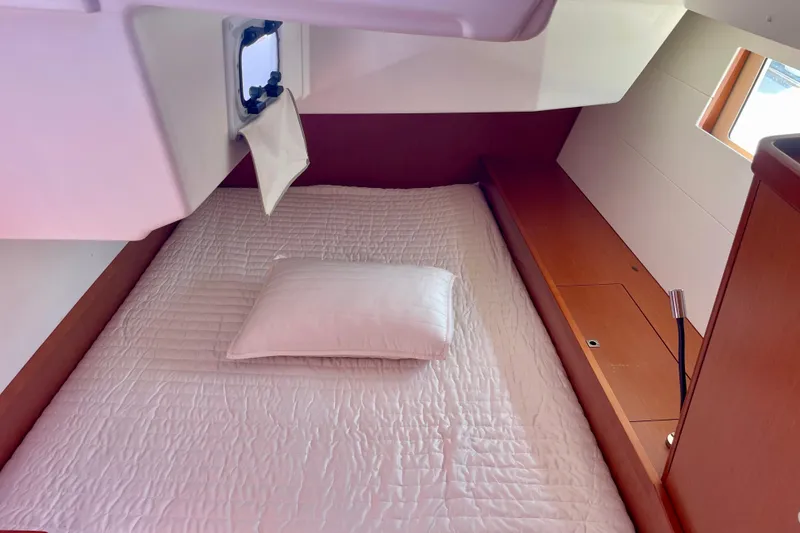 Slide: The Image of Cozy cabin interior of 2018 Beneteau Oceanis 48 yacht with bed and porthole. - 52