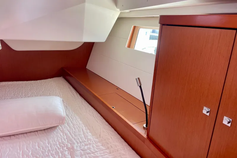 Slide: The Image of Cozy cabin interior of 2018 Beneteau Oceanis 48 with wooden cabinetry and bedding. - 53
