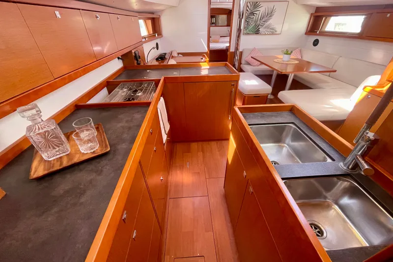 Slide: The Image of Luxurious 2018 Beneteau Oceanis 48 yacht interior with modern kitchen and dining area. - 55