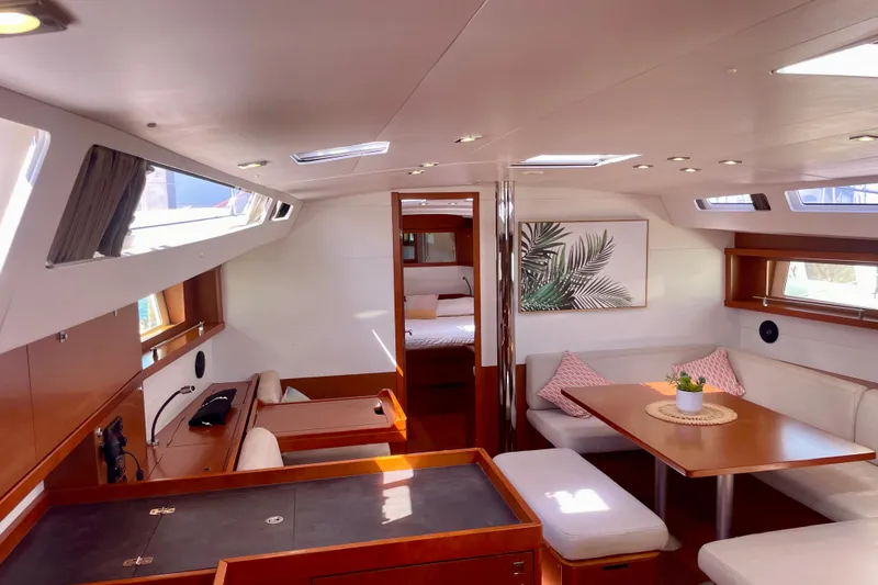 Slide: The Image of Luxurious interior of 2018 Beneteau Oceanis 48 yacht with modern furnishings and ample natural light. - 58