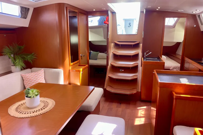 Slide: The Image of Interior of 2018 Beneteau Oceanis 48 yacht with elegant wood finish and modern furnishings. - 61