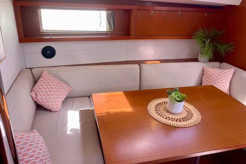 Slide: The Image of Interior of 2018 Beneteau Oceanis 48 yacht with cozy seating and decorative plants. - 62