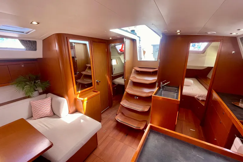 Slide: The Image of Interior of 2018 Beneteau Oceanis 48 yacht, featuring cozy seating and elegant wood finishes. - 72
