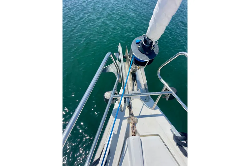 Slide: The Image of Bow of 2018 Beneteau Oceanis 48 sailboat with anchor and railing over water. - 8