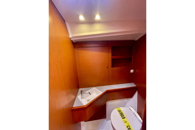 Slide: The Image of Interior of 2018 Beneteau Oceanis 48 yacht bathroom with wooden cabinetry and modern fixtures. - 80