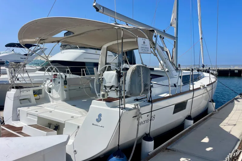 Slide: The Image of 2018 Beneteau Oceanis 48 yacht docked at marina, featuring spacious deck and modern design. - 85
