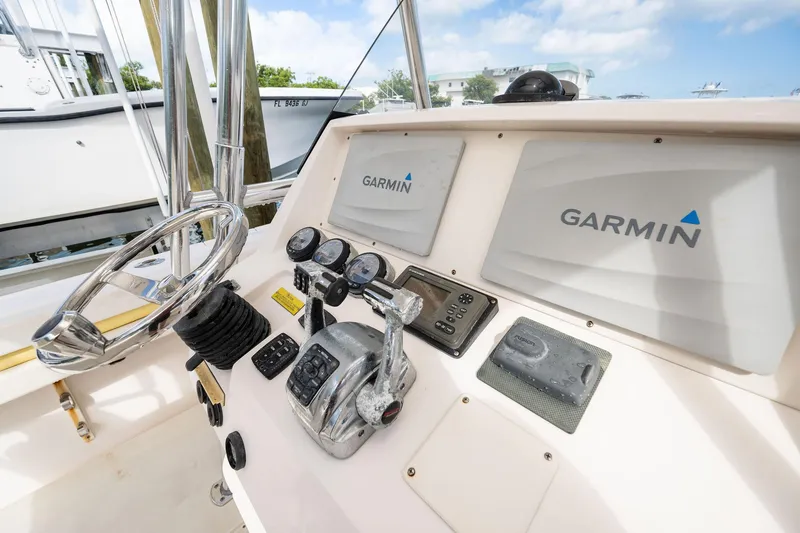 Slide: The Image of 2009 Intrepid 323 CC boat dashboard with Garmin navigation system and controls. - 10