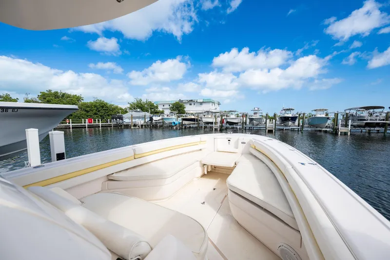 Slide: The Image of 2009 Intrepid 323 CC boat docked at marina under blue sky. - 11