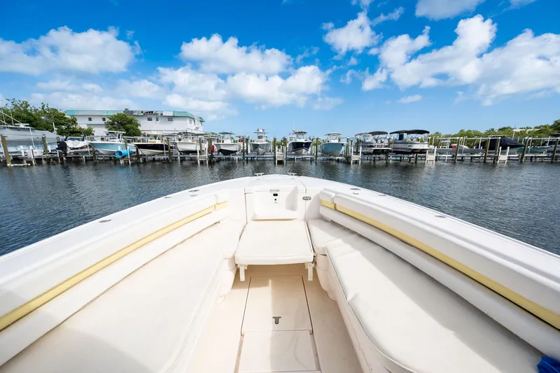 Slide: The Image of 2009 Intrepid 323 CC boat docked at marina under blue sky. - 12