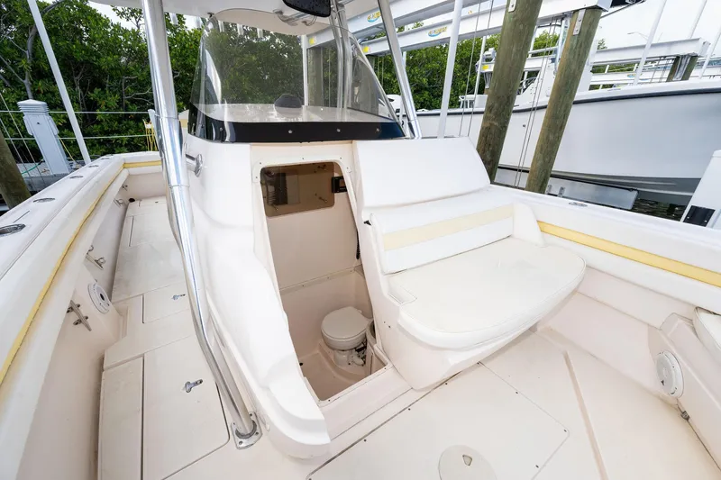 Slide: The Image of 2009 Intrepid 323 CC boat interior with open cabin and seating area. - 14