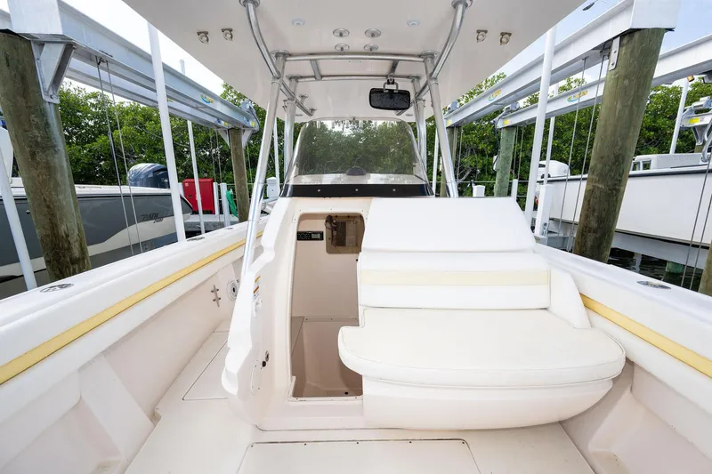 Slide: The Image of 2009 Intrepid 323 CC boat interior with white seating and helm station. - 15