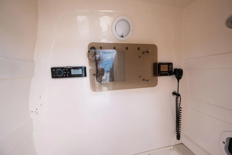 Slide: The Image of Interior of a 2009 Intrepid 323 CC boat with radio and communication equipment. - 18