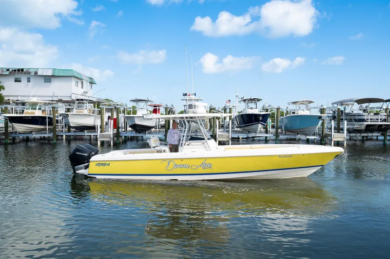 Slide: The Image of 2009 Intrepid 323 CC boat docked in marina, sunny day, blue sky. - 27