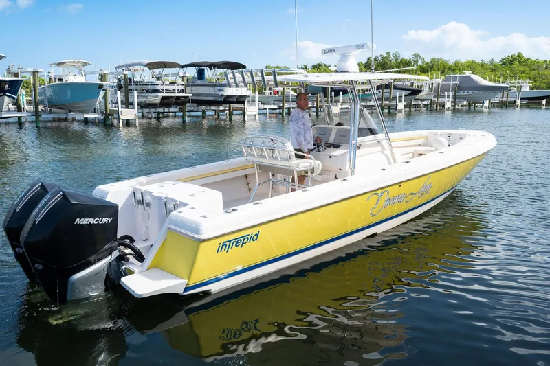 Slide: The Image of 2009 Intrepid 323 CC boat with Mercury engines docked in marina. - 29