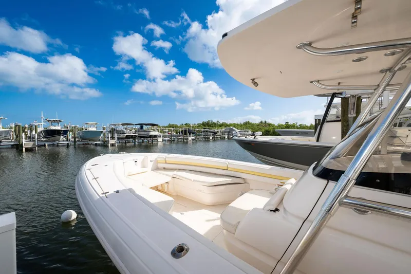 Slide: The Image of 2009 Intrepid 323 CC boat docked at marina under clear blue sky. - 4