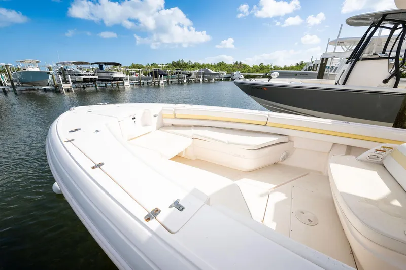 Slide: The Image of 2009 Intrepid 323 CC boat docked at marina under blue sky. - 5