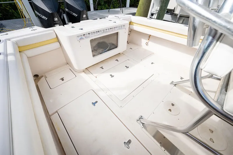Slide: The Image of 2009 Intrepid 323 CC boat deck with storage compartments and Mercury engines. - 8