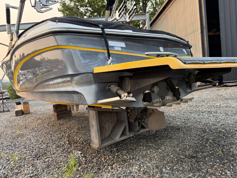Slide: The Image of 2015 MasterCraft X10 boat on blocks, showcasing hull and propeller details. - 10
