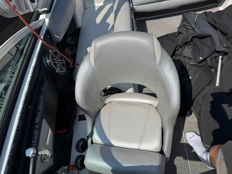 Slide: The Image of 2015 MasterCraft X10 boat interior with white seating and speaker system. - 7