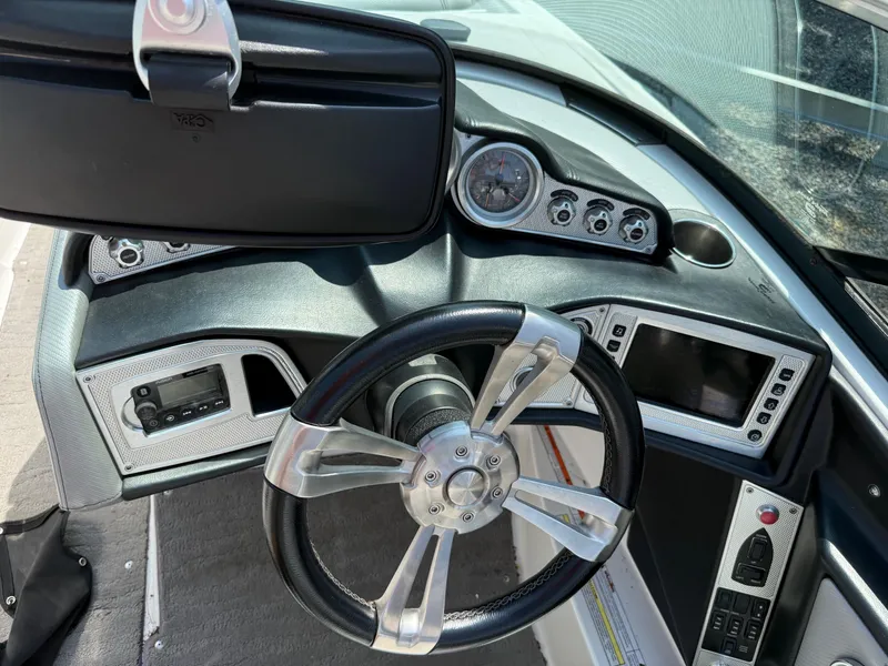 Slide: The Image of 2015 MasterCraft X10 boat dashboard with steering wheel and control panel. - 8