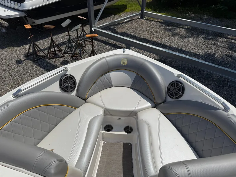 Slide: The Image of 2015 MasterCraft X10 boat interior with gray seating and speakers. - 9