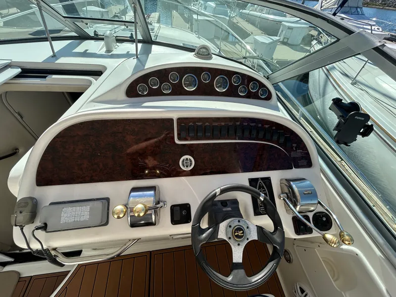 Slide: The Image of Cockpit of 2001 Sea Ray 310 Sundancer with steering wheel and control panel. - 4