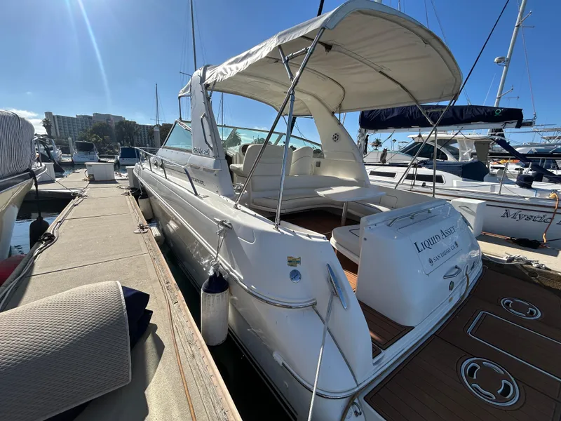 Slide: The Image of 2001 Sea Ray 310 Sundancer docked at marina under clear blue sky. - 9