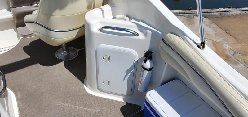 Slide: The Image of 2003 Wellcraft 2400 Martinique boat interior with seating, storage, and fire extinguisher. - 10