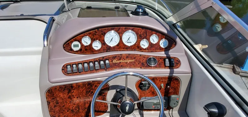 Slide: The Image of Dashboard of a 2003 Wellcraft 2400 Martinique boat with wood paneling and gauges. - 11